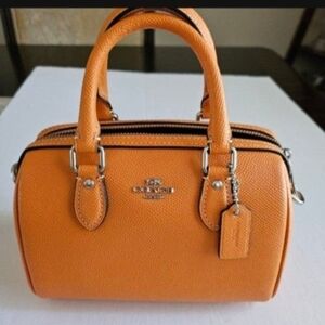Coach Orange Mini Rowan Bag with High-Quality Leather and Minimalist Design